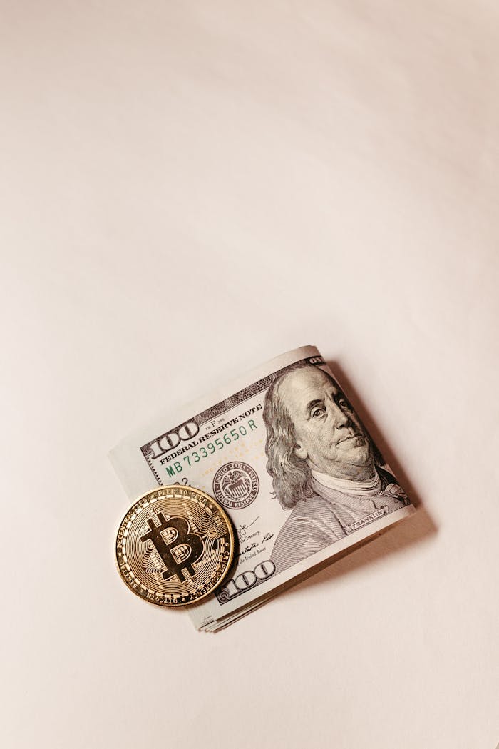 Bitcoin coin placed over US dollar note symbolizes digital vs traditional currency.